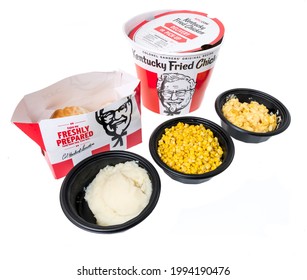 Winneconne, WI - 20 June 2021:  A package of KFC Kentucky Fried Chicken bucket with mashed potatoes, whole kernal corn and mac and cheese colonel sanders on an isolated background