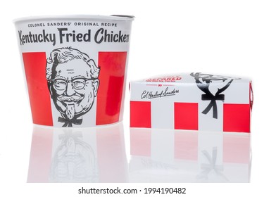 Winneconne, WI - 20 June 2021:  A package of KFC Kentucky Fried Chicken bucket with biscuits colonel sanders on an isolated background