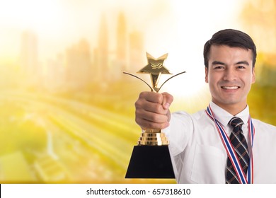 
Winner Businessman Holding Golden Trophy After Success In His Business.