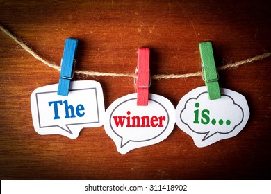 The winner is concept paper speech bubbles with line on the wooden background.