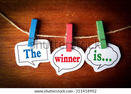 The winner is concept paper speech bubbles with line on the wooden background.