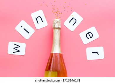 Winner congratulation concept with champagne on pink background top view