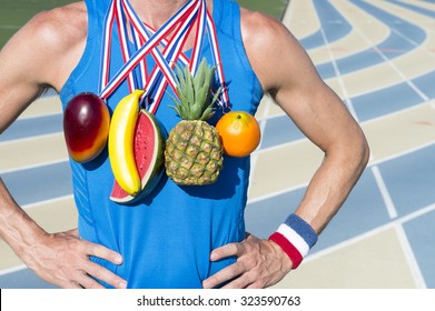 Winner Of Healthy Eating Competition Standing At Running Track With Fruit Medals Including Orange, Watermelon, Banana, Mango, And Pineapple