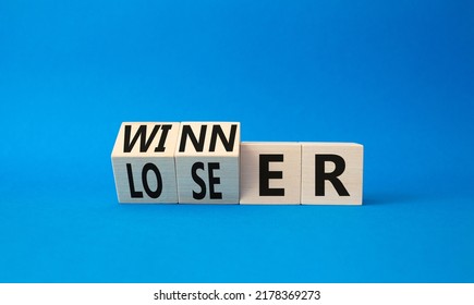 Winner And Loser Symbol. Turned Wooden Cubes With Words Winner And Loser. Beautiful Blue Background. Business And Winner And Loser Concept. Copy Space