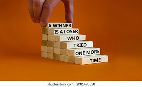 Winner Or Loser Symbol. Wooden Blocks With Words A Winner Is A Loser Who Tried One More Time. Beautiful Orange Background, Copy Space. Businessman Hand. Business, Winner Or Loser Concept.