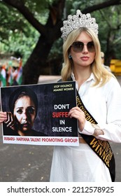 Winner Of Miss Supermodel Worldwide 2018 Pageant Holds A Placard During An International Campaign For Save Girl Child And Domestic Violence Against Women In New Delhi, India On 11 October 2022. 