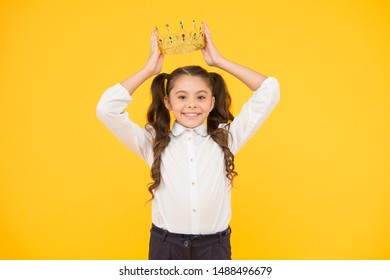 Winner Revealed Happy Little Prize Winner Putting Crown Jewel On Head On Yellow Background. Adorable School Award Winner Smiling With Luxury Fashion Accessory. Scholarship Winner.