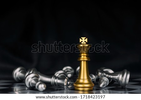 Winner. shot of golden king surrounded with silver chess pieces on chess board game competition with dark background, chess battle, victory, success, team leader, teamwork, business strategy concept