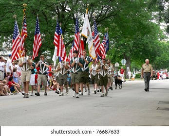 WINNETKA, ILLINOIS - JULY 4: A Troop Of Boy Scouts Marches In A Fourth Of July Parade On July 4, 2007 With Unidentified Spectators In The Background In WINNETKA, ILLINOIS.