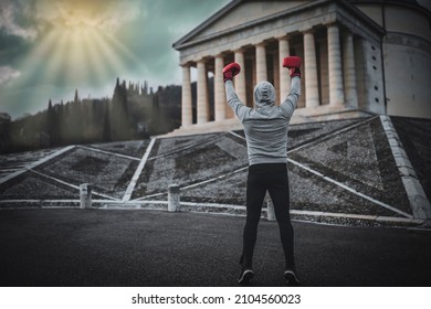 Winning boxer raises his hands high. Victory at the Rocky Balboa. - Shutterstock ID 2104560023