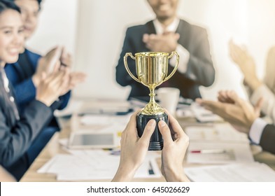 winning business team gold trophy , business team happy consent and successful business team rewarded for in the office - Shutterstock ID 645026629