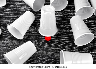 The Winning Cup In The Shell Game With A Prize Red Ball. Around Lie Empty Losing Cups. The Concept Of Good Luck In The Game And Life