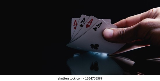 Winning poker hand of four aces playing cards