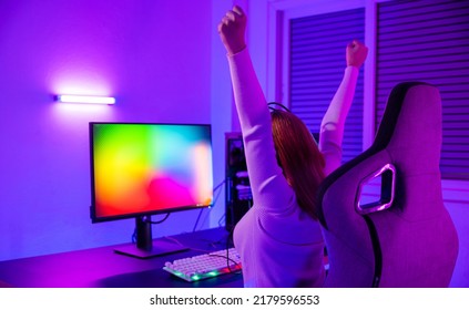 Winning Victory. Asian Gamer Playing Online Video Game Excited On Desktop Computer PC Colorful Neon LED Lights, Young Woman In Gaming Headphones Using Computer She Happy Successful, E-Sport Concept