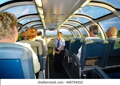 Winnipeg Manitoba Canada 6 June 2012 . Lovely Via Rail Train Hostess Stewardess
Attending To Retirees Travelling Across The Country On Vacation. Golden Sunbeams From The Setting Sun .