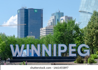 Winnipeg, Manitoba / Canada - July 13 2019: Winnipeg Sign with Downtown Skyline in the Background