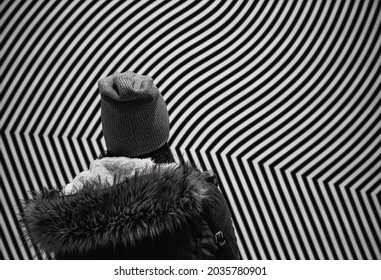 Winnipeg, Manitoba, Canada, July 18th 2020: Woman Female Figure Stands In Front Of Abstract Black And White Art Piece Design Experimental Observing Seeing Framed Lost In Message High Concept Lines 