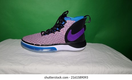 Winnipeg Manitoba Canada - July 5th 2021: Nike SB Trainer Running High Top basketball shoe wild colors purple blue black translucent for sale pictured against a green screen and white background