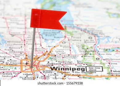Winnipeg in Manitoba, Canada. Red flag pin on an old map showing travel destination.