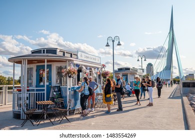 Winnipeg, Manitoba/Canada - August 2019: People lined up for the Crêperie Ker Breizh, which sells crêpes, located at the end of the Esplanade Riel pedestrian bridge. Shot on a summer afternoon.