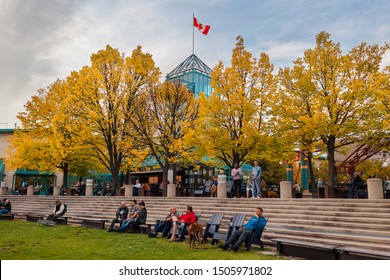 Winnipeg, Manitoba/Canada - September 2019: People relaxing outside the Forks Market, with the trees already showing their fall colors