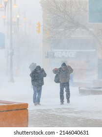 Winnipeg, MB, Canada - April 2022: People Walking On The Street During A Blizzard