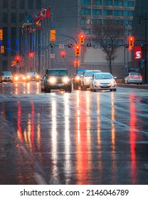 Winnipeg, MB, Canada - April 2022: Headlights And Street Lights Reflected On A Wet Street