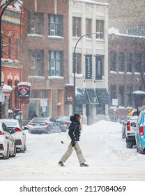 Winnipeg, MB Canada - January 2022: Person Crossing The Street During A Snow Storm