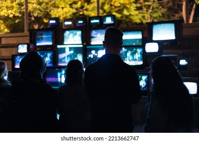 Winnipeg, MB, Canada - September 2022: Silhouette Of People Looking At An Art Installation At The Forks During Nuit Blanche