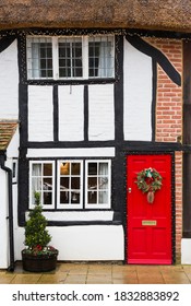 WINSLOW, UK - December 26, 2019. Christmas Decorations Outside Old Thatched Cottage House In UK, Winter Street Scene