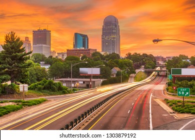 Winston-Salem, North Carolina, USA skyline and highways at dusk.
