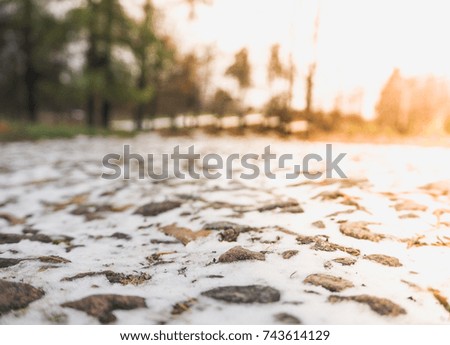 Winter abstract background. Winter road with the setting sun.