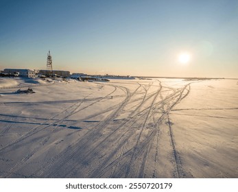 The winter aerial view of Pechora river, with snowmobile trails, and winter December landscape in Naryan-Mar, Russian Arctic North.
 - Powered by Shutterstock