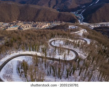 Winter Aerial View Of The Road To Ski Resort Krasnaya Polyana. Beautiful Winter Landscape From Drone.