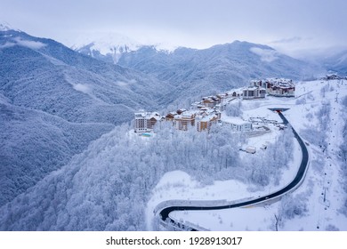 Winter aerial view of the Ski Resort Rosa Khutor and the mountain road to it. Beautiful winter landscape with frost-covered trees. Krasnaya Polyana, Sochi, Russia - Powered by Shutterstock