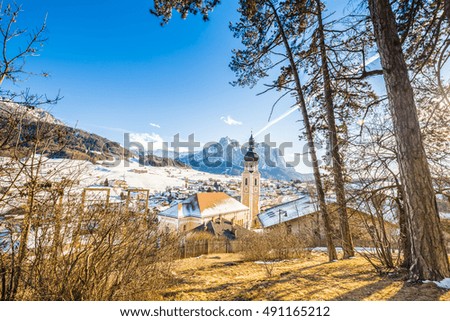 winter Alpine landscape in Italy, mountain village and snowy peaks