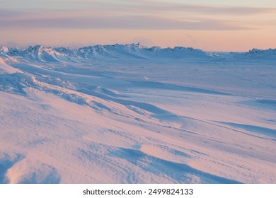 Winter arctic landscape. Cold frosty winter weather. Harsh polar climate. Ice hummocks on the frozen sea in the Arctic. View of snow and ice at sunset. Picturesque nature of the Arctic. Far North. - Powered by Shutterstock