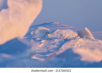 Winter Arctic Landscape. View Of Ice Hummocks And Snowdrifts. The Frozen Sea. Snow-covered Ice Floes Close-up. Cold Frosty Winter Weather. Polar Region. Blurred Foreground. Shallow Depth Of Field.