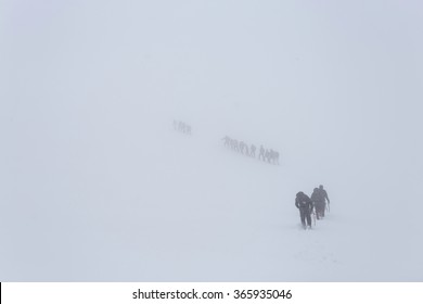 Winter ascent of the mountain climbers in the snow storm (blizzard). Carpathian, Ukraine, Europe.  (hi res, high quality)