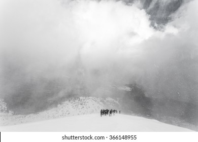 Winter ascent of the mountain climbers in the snow storm (blizzard). Carpathian, Ukraine, Europe