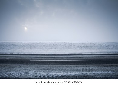 Winter Asphalt Road And Snowy Field In Fog, Side View