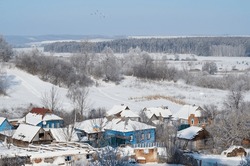 Winter Atmosphere In The Village, Frost On The Trees And A Snowy Rural House.