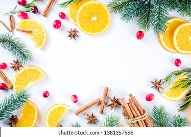 Winter Autumn Drink And Food Ingredients. Cranberries, Sliced Oranges, Cinnamon, Rosemary, Anise For Cooking Cocktails, With Christmas Tree Branches. Flatlay On White Background. Top View Copy Space