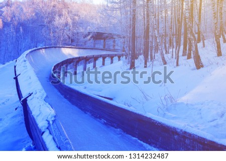 winter background bobsled track in the forest