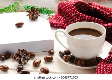 Winter background - cup with candy cane, woolen scarf on windowsill and winter scene outdoors