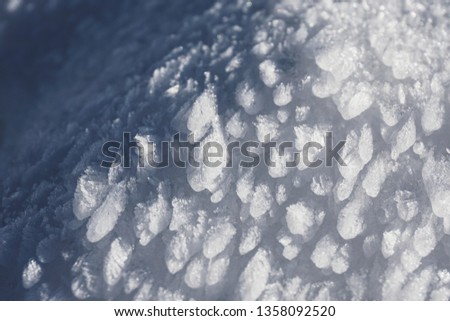 Winter background - ice particles - frozen surface of snow - close-up shot
