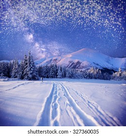 Winter background with some soft highlights and snow flakes. The look seems to be through a snowy window.