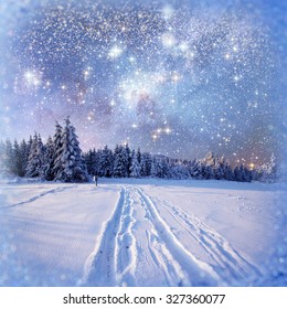 Winter background with some soft highlights and snow flakes. The look seems to be through a snowy window.