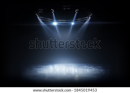 Winter background. Spotlight shines on the rink. Bright lighting with spotlights. Beautiful empty winter background and empty ice rink with lights