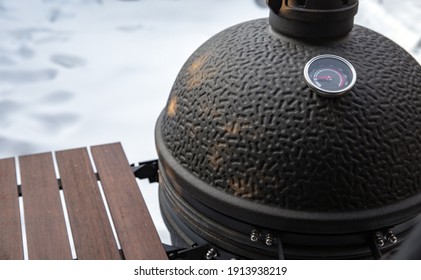 Winter bbq in the fresh white snow, Men grilling chicken wings in the winter onn grill close up